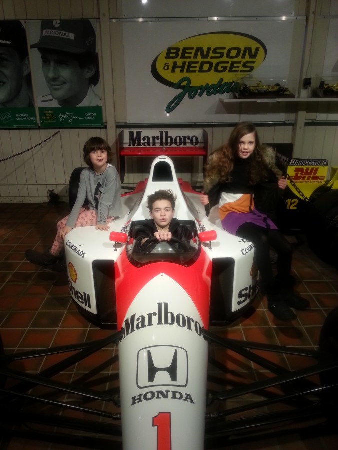 Kids posing on Sennas car