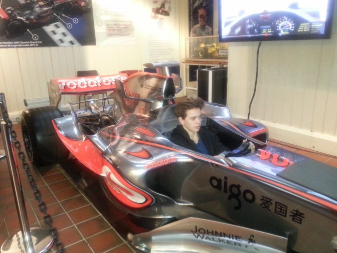 Wills enjoying the F1 simulator in Lewis Hamilton's 2008 McLaren show car.